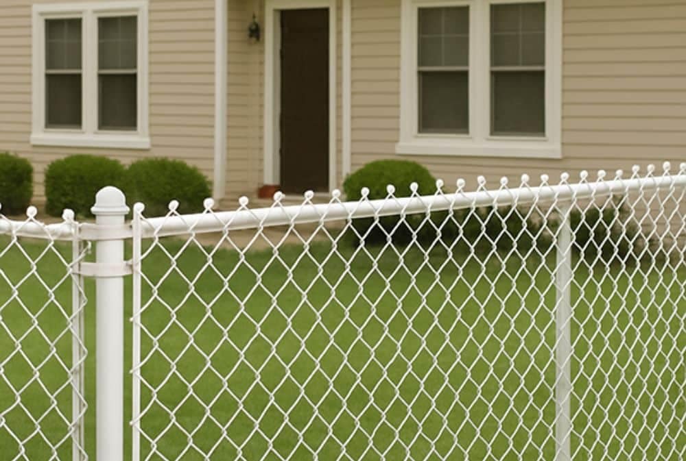 White chain link fencing in front of a house