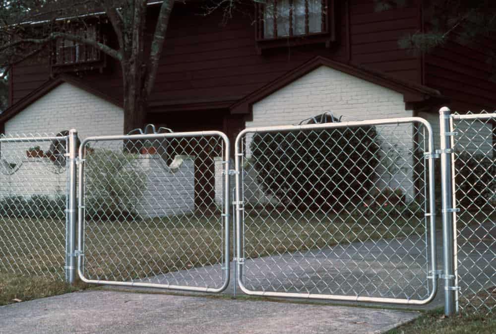 Chain link fence and chain link driveway gate.