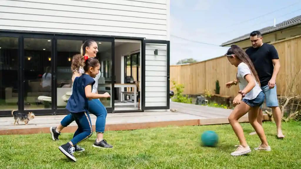 Children playin in backyard with fence from Element Fence Company
