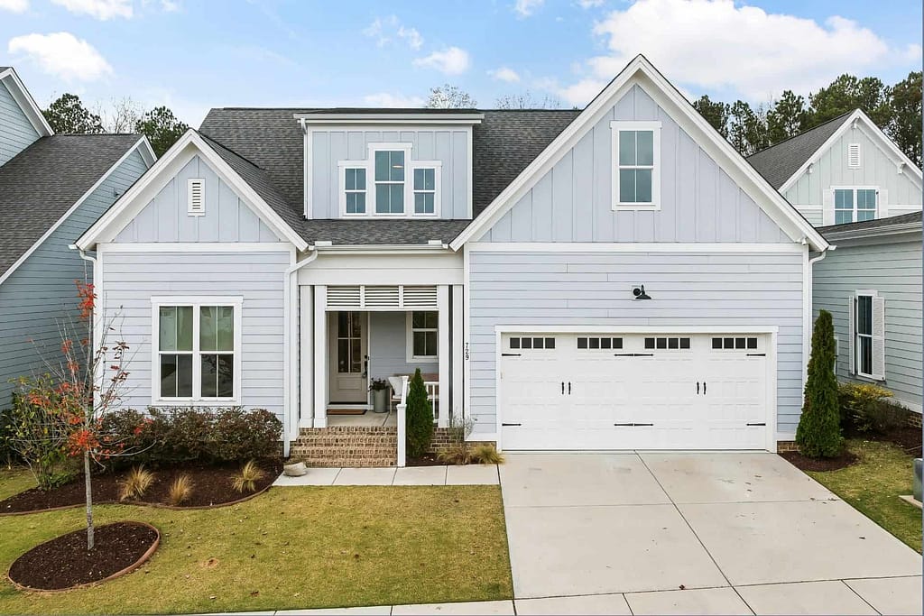the front of a new construction home showing the yard and garage door