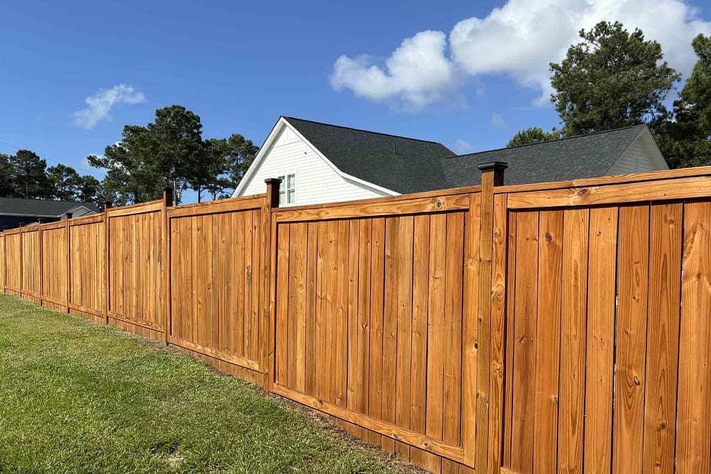 tall stained wood privacy fence at a coastal North Carolina property